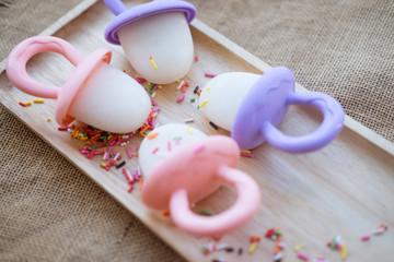 Milk popsicles (selective focus; close-up shot)