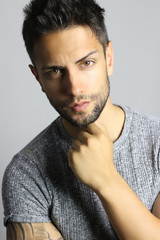 Portrait of a sexy young man . Gray background. Men's health.
