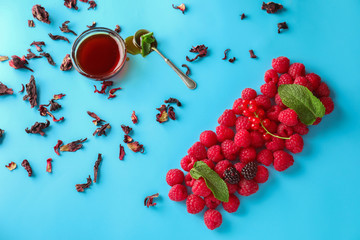 Composition with fresh ripe berries and honey on color background © Pixel-Shot