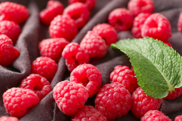 Fresh ripe raspberries on cloth, closeup