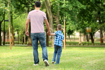 Fototapeta premium Little boy and his father walking outdoors