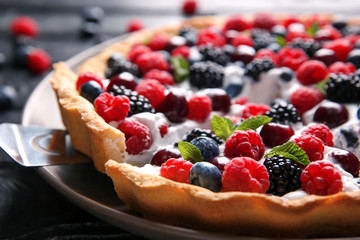Delicious berry pie with slice on shovel, closeup