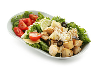 Plate with tasty Caesar salad on white background