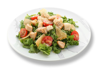 Plate with tasty Caesar salad on white background
