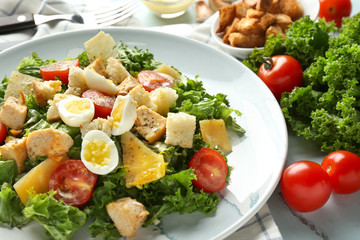 Tasty Caesar salad on plate, closeup