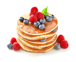 Tasty homemade pancakes with berries on white background