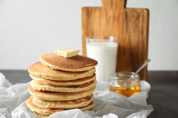 Fototapeta na wymiar Tasty pancakes with butter on table