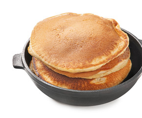 Frying pan with tasty pancakes on white background, closeup
