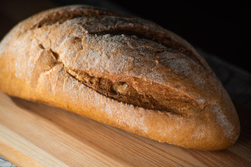 Healthy organic homemade bread on wooden table.
