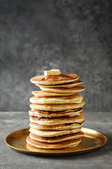 Plate with tasty homemade pancakes on table
