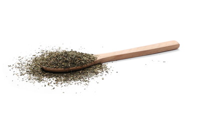 Pile of dried oregano spice, leaves with wooden spoon isolated on white background