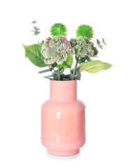 Vase with green plants on white background
