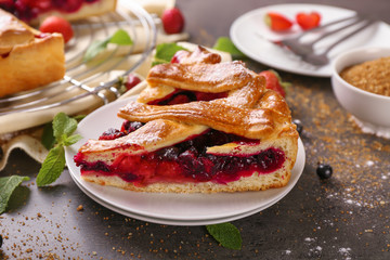 Piece of tasty pie with berries on plate