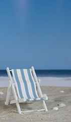 Blue white striped deck chair on the beach