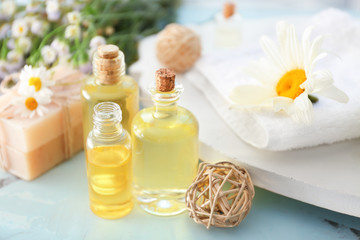 Fototapeta na wymiar Bottles of essential oil on table