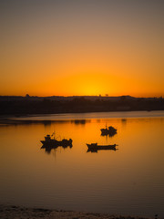 Obraz na płótnie Canvas Sunrise at quellón channel with fishing boats