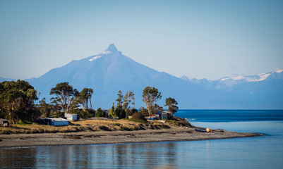 Quellon channel in Chiloé island, chile. With the andes range and Corcovado volcano