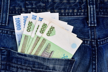 Uzbek national money in a jeans pocket