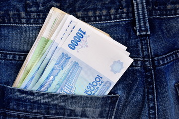 Uzbek national money in a jeans pocket