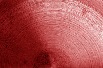 Old metal surface with scratches in red tone.