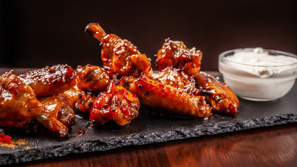 American cuisine, fried chicken wings barbecue in glaze sauce. The concept of American street food.