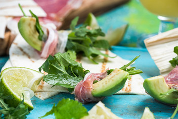 Healthy brunch, avocado wrapped in ham and salad