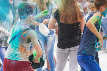 Holi Festival of Colors. People throw dry colored paint in the air at the festival Holi