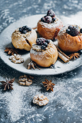 Fruit dessert baked  apples stuffed with blackberry, blueberries, cinnamon, nuts, honey. Autumn or winter dessert.