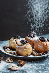 Fruit dessert baked  apples stuffed with blackberry, blueberries, cinnamon, nuts, honey. Autumn or winter dessert.