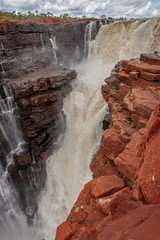 Portrait  view at the top of one of the twin King George Falls in flood, Kimberley, Australia
