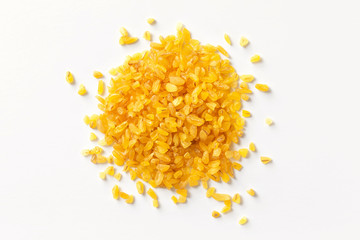 Pile of bulgur raw grain isolated at white background. Macro top view image.
