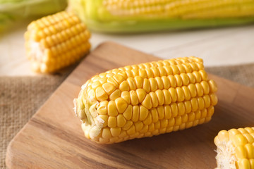 Fresh cut corn cob on wooden board