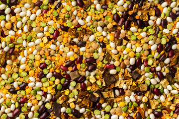 Macro image of beans and peas mix with dried eggplants with spices as natural vegan background. Top view