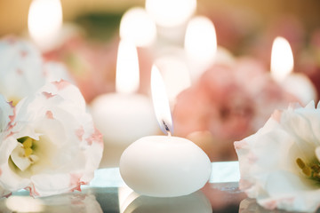 Close-up of candles and flowers.