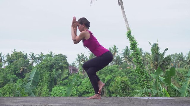 Yoga concept. Garudasana pose. Young woman practices yoga.