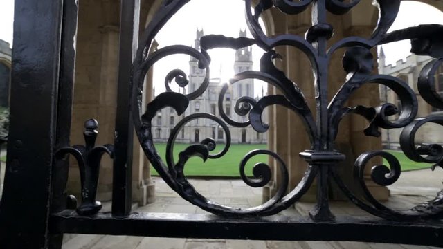 All Souls Oxford through cast iron gates early morning slider dolly shot