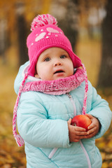 little girl with autumn harvest in park