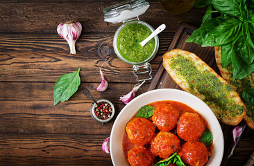 Meatballs in tomato sauce and toast with basil pesto. Dinner. Tasty food. Top view. Flat lay