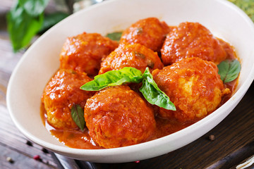 Meatballs in tomato sauce and toast with basil pesto. Dinner. Tasty food.