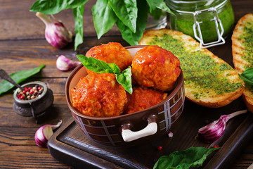 Meatballs in tomato sauce and toast with basil pesto. Dinner. Tasty food.