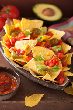 nachos loaded with salsa, cheese, guacamole and jalapeno