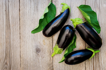 Ripe eggplants on a wooden background. Top view, flat lay.