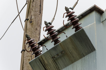 Electricity transformer high on wood mounting outdoors