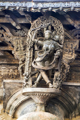 Shilabalika, celestial maiden, as a Kapikupite. Monkey, in the bottom left corner, pulling Saree. Chennakeshava temple, Belur, Karnataka. Notice the hairstyle.