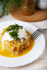 Lazy cabbage rolls on a wooden table.