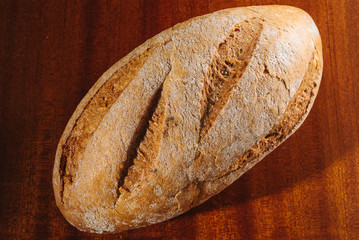 Healthy organic homemade bread on wooden table.