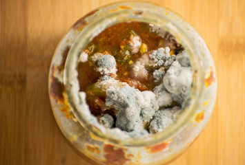 Blue and green mold in a can of canned vegetables