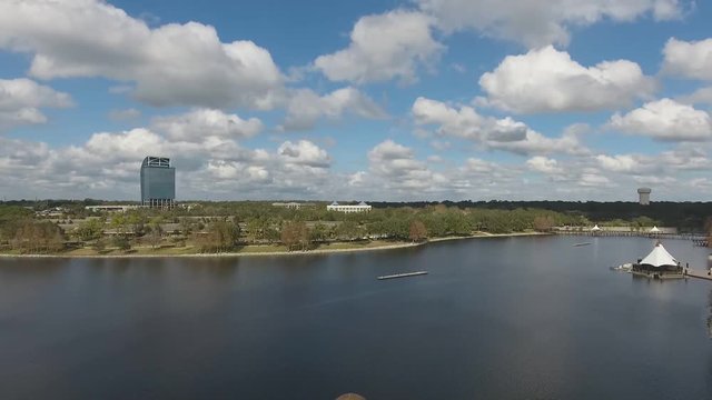 This is a shot that pans up from a modern park plaza to reveal a city skyline. The featured building is called the Majesty Building.