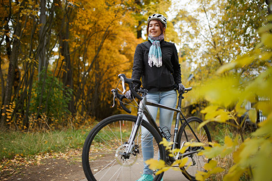 Image of woman with bicycle in helmet
