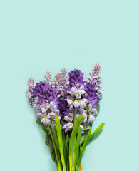Fototapeta premium Wedding Hand Flower Bouquet Lie on Turquoise Paper Background. Concept of Love and Romantic Expression or Say it with flowers